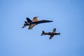 A yellow and black colored fighter jet flying in close range to