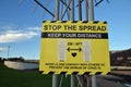 Yellow and black COVID sign in Scotland with protest stickers attached. Royalty Free Stock Photo