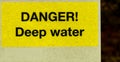 Yellow and black danger deep water sign Royalty Free Stock Photo