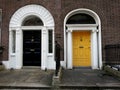 Yellow and black doors in gerogian city house, Dublin. Royalty Free Stock Photo