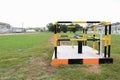 Yellow and black iron fence around small groundwater pump Royalty Free Stock Photo