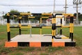 Yellow and black iron fence around small groundwater pump Royalty Free Stock Photo