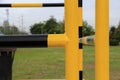 Yellow and black iron fence around small groundwater pump Royalty Free Stock Photo