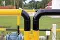 Yellow and black iron fence around small groundwater pump Royalty Free Stock Photo