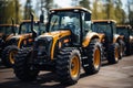A yellow black machines parked with a other tractor in parking, construction and engineering image