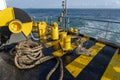 The deck of the ferry boat along with the a thick mooring rope and blue sea water wave, Thailand. Close up Royalty Free Stock Photo