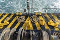 The deck of the ferry boat along with the a thick mooring rope and blue sea water wave, Thailand. Close up Royalty Free Stock Photo