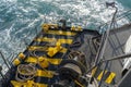 The deck of the ferry boat along with the a thick mooring rope and blue sea water wave, Thailand. Close up Royalty Free Stock Photo