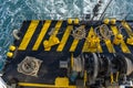 The deck of the ferry boat along with the a thick mooring rope and blue sea water wave, Thailand. Close up Royalty Free Stock Photo