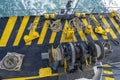 The deck of the ferry boat along with the a thick mooring rope and blue sea water wave, Thailand. Close up Royalty Free Stock Photo