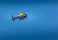 Yellow and Black Police Helicopter flying in sky