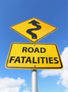 A yellow and black Road Fatalities sign with curvy upward arrow in blue sky Royalty Free Stock Photo