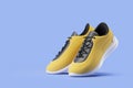 Yellow and black sport shoes over blue Royalty Free Stock Photo