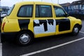 Yellow and black taxi cab in London, England