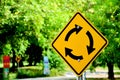 Yellow and black traffic circle sign in country road