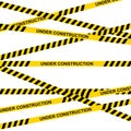 Yellow and black warning tapes with text under construction isolated on white background. Police insulation line, signs Royalty Free Stock Photo