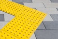 Yellow blocks of tactile paving for blind handicap. Braille blocks, tactile tiles for the visually impaired, Tenji blocks.