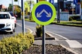 Yellow and blue circular metal road traffic sign with directional arrows Royalty Free Stock Photo