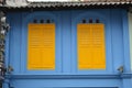 Yellow and blue colonial windows and shutters in Little India , Singapore