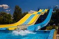 Yellow and blue color water slide in aquapark Royalty Free Stock Photo