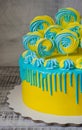 Yellow and blue cream cheese color drip cake with merengues Royalty Free Stock Photo