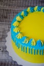 Yellow and blue cream cheese color drip cake with merengues Royalty Free Stock Photo