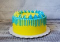 Yellow and blue cream cheese color drip cake with merengues Royalty Free Stock Photo