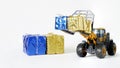 Yellow and blue gift boxes and a toy forklift. Concept of humanitarian assistance to citizens of Ukraine. Collection and delivery