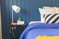 Yellow and blue graphic print pillow setting in teen bedroom.