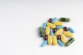 Yellow, blue, green and purple pills isolated on a white background. Diseases Royalty Free Stock Photo