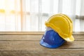 yellow, blue hard safety helmet construction hat for safety project of workman as engineer or worker Royalty Free Stock Photo