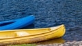 Yellow and blue kayaks on the river waiting for tourists Royalty Free Stock Photo