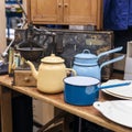 blue and blue ladles and teapots against the background of an old coffee grinder in an antique market