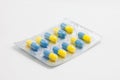 Yellow-blue medical capsules in blister package