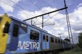 Yellow blue Metro Train (motion blur) runs in the Brunswick suburb of Melbourne, Australia