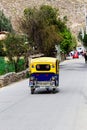 Yellow And Blue Mototaxi Going Down Street Ollantaytambo Peru