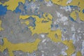 Yellow and blue paint is peeling off the plastered wall Royalty Free Stock Photo