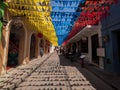 Yellow blue red colombia national flag pennant chain over historical colonial street road in Cartagena de Indias Bolivar