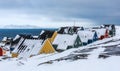 Yellow, blue, red and green inuit houses covered in snow at the fjord of Nuuk city, Greenland Royalty Free Stock Photo