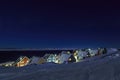 Yellow, blue, red and green inuit houses covered in snow at the fjord under the starlight sky, Nuuk city, Greenland Royalty Free Stock Photo