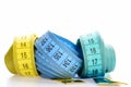 Yellow and blue rolled measuring tapes on white background. Royalty Free Stock Photo