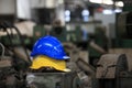 Yellow and blue safety hat for working industry area Royalty Free Stock Photo