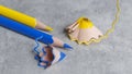 yellow and blue sharp pencil and blue and yellow pencil shavings. Royalty Free Stock Photo