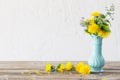 The yellow and blue spring flowers s in blue vase on white background Royalty Free Stock Photo