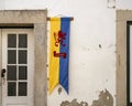 Yellow and blue striped flag with a heraldic red lion in rampant position in Obidos, Portugal.