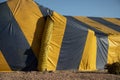 Yellow and blue striped termite tent covering a ranch style house Royalty Free Stock Photo