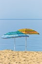 Yellow and blue sunshades on sandy beach against blue sky in Sithonia Royalty Free Stock Photo