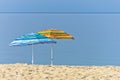 Yellow and blue sunshades on sandy beach against blue sky in Sithonia Royalty Free Stock Photo