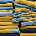 Yellow and blue T-shirts lie in a stack. The concept of diversity in the world and freedom of choice