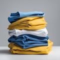 Yellow and blue T-shirts lie in a stack. The concept of diversity in the world and freedom of choice